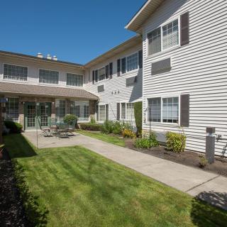 A well-maintained residential building with a neatly landscaped outdoor area.