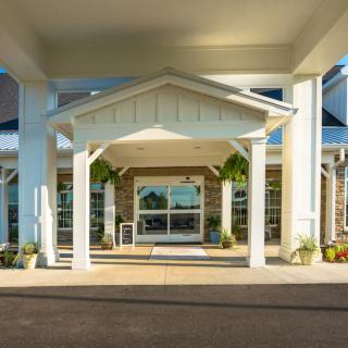 A covered entrance to a modern building on a sunny day.