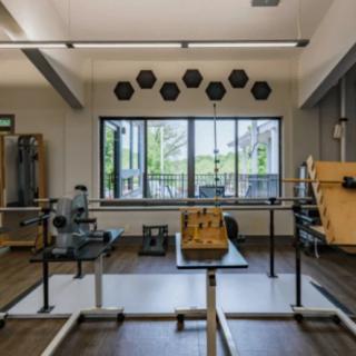 A well-equipped gym with various exercise machines and weights in a modern workout room.
