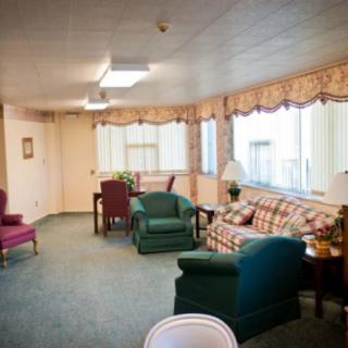 A cozy living room featuring comfortable seating and ample natural light.