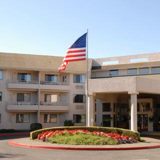 A hotel entrance with an American flag prominently displayed.