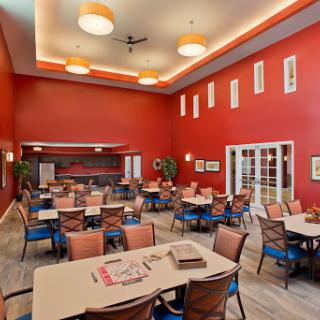 A vibrant dining area featuring red walls and comfortable seating.