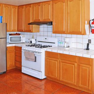 A modern kitchen with wooden cabinets and stainless steel appliances.