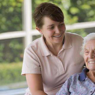 A caregiver shares a joyful moment with an elderly resident, highlighting the importance of companionship and care.