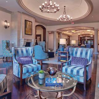 A luxurious hotel lobby featuring elegant furniture and chandeliers.