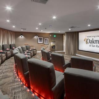 A cozy home theater with comfortable seating and a large screen for movie viewing.