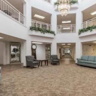 A spacious lobby with elegant furnishings and a large chandelier.