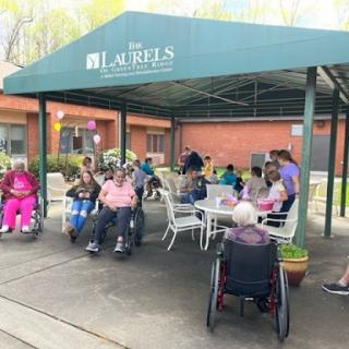 Residents enjoying a sunny day outdoors at the community center.