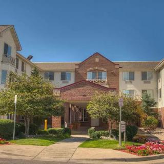 A welcoming residential building with well-maintained landscaping on a sunny day.