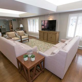 A spacious living room with a large sectional sofa and a television.
