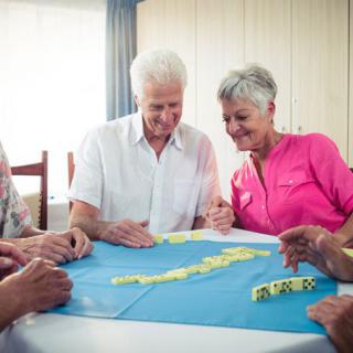 A group of seniors enjoying a game together indoors.