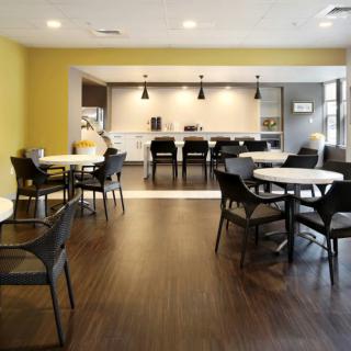 A modern dining area with stylish furniture and lighting.