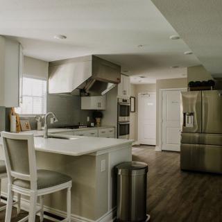 A modern kitchen with stainless steel appliances and a central island.