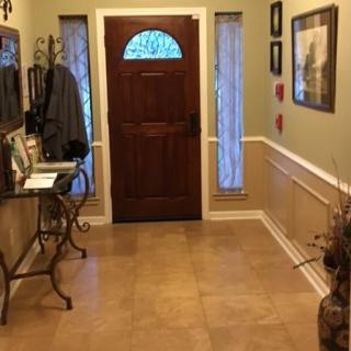 A welcoming entryway with a wooden door and decorative elements.