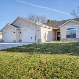 A suburban house with a well-maintained lawn and a spacious driveway.
