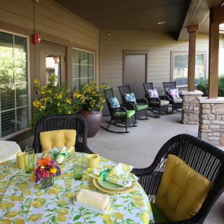 Charming outdoor patio with a beautifully set table and cozy seating area.