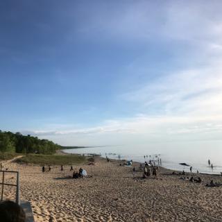 A serene beach scene with gentle waves and clear skies, perfect for a relaxing day outdoors.
