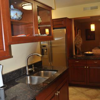 A modern kitchen with wooden cabinets and stainless steel appliances.