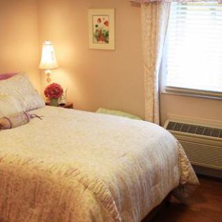 A cozy and neatly arranged bedroom with soft lighting.