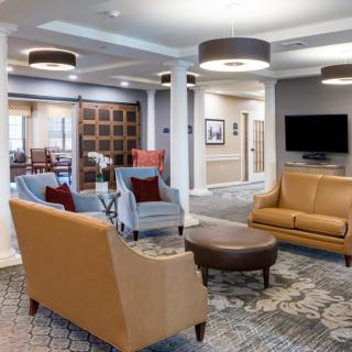 A modern lobby area with comfortable seating and a television.