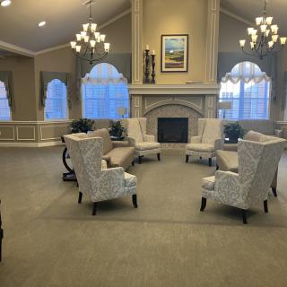 A cozy living room with elegant seating arrangements and a fireplace.