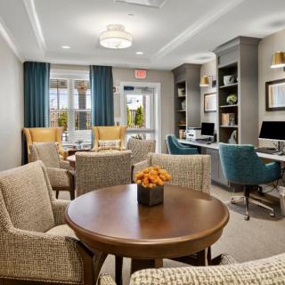 A modern lounge with comfortable seating, workstations, and stylish decor.