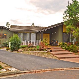 A suburban house with a driveway and well-maintained landscaping.