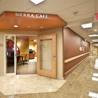 Entrance to a modern cafe in a hallway setting.