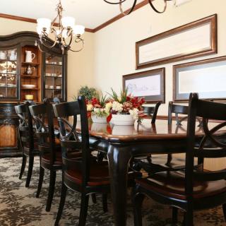 Elegant dining room setup with a large table and ornate chandelier.