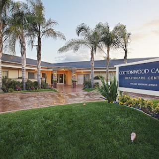 Cedarwood Care, a healthcare facility, with palm trees and well-maintained landscaping.