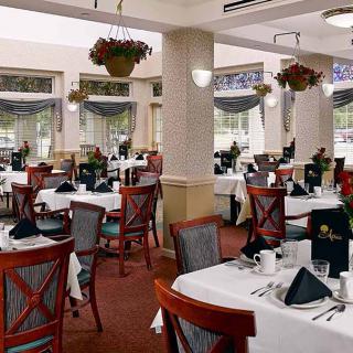 An elegant restaurant dining area with neatly arranged tables and chairs.
