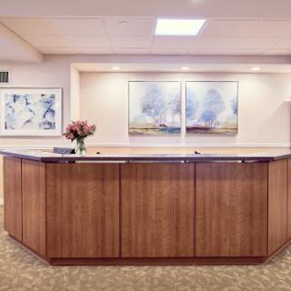 A welcoming reception area featuring a wooden counter and modern artwork.