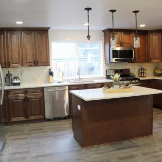 A modern kitchen with wooden cabinets and a central island.