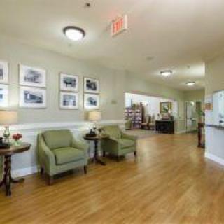 A cozy lobby area with seating and artwork on the walls.