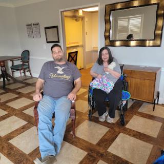 Two individuals seated in a communal area, enjoying their time together.