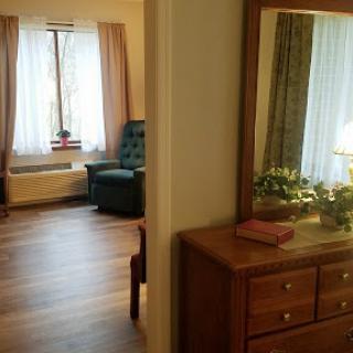 A view of a cozy living space with natural light highlighting the furniture and decor.