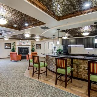 A cozy lounge area with a bar counter, comfortable seating, and elegant decor.