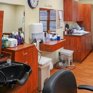 A well-organized hair salon interior with styling chairs, mirrors, and beauty products.
