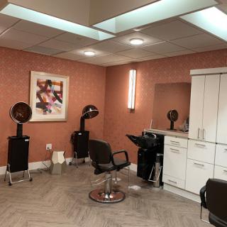 A modern hair salon with stylish furniture and equipment.