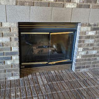 A modern fireplace framed by stylish brickwork, perfect for cozy gatherings.