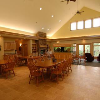 Spacious dining area with wooden furniture and a cozy fireplace.