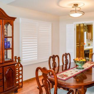 A well-furnished dining room with a wooden table, chairs, and a china cabinet.