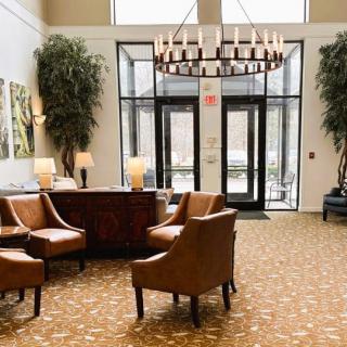 A well-appointed lobby with comfortable seating and a large chandelier.