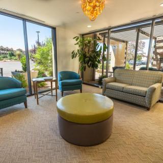A modern waiting room with comfortable seating and abundant natural light.