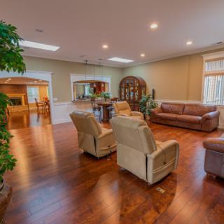 A spacious and inviting living room featuring comfortable seating and warm lighting.