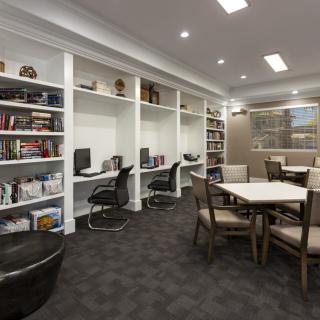 A modern library with computers and a comfortable study area.