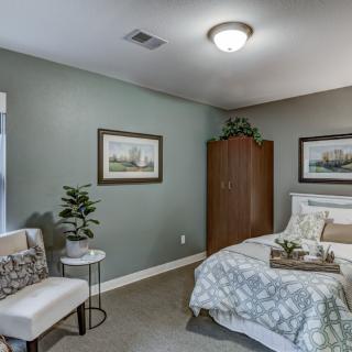 A modern and comfortable bedroom with tasteful decor and furniture.