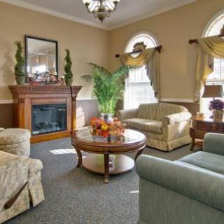A traditional living room with comfortable seating, a fireplace, and elegant decor.