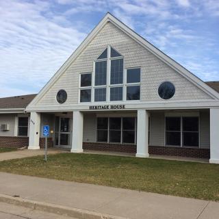 A public library building with a triangular roof and prominent windows.
