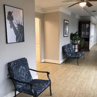 A cozy hallway featuring stylish seating and artistic decor.